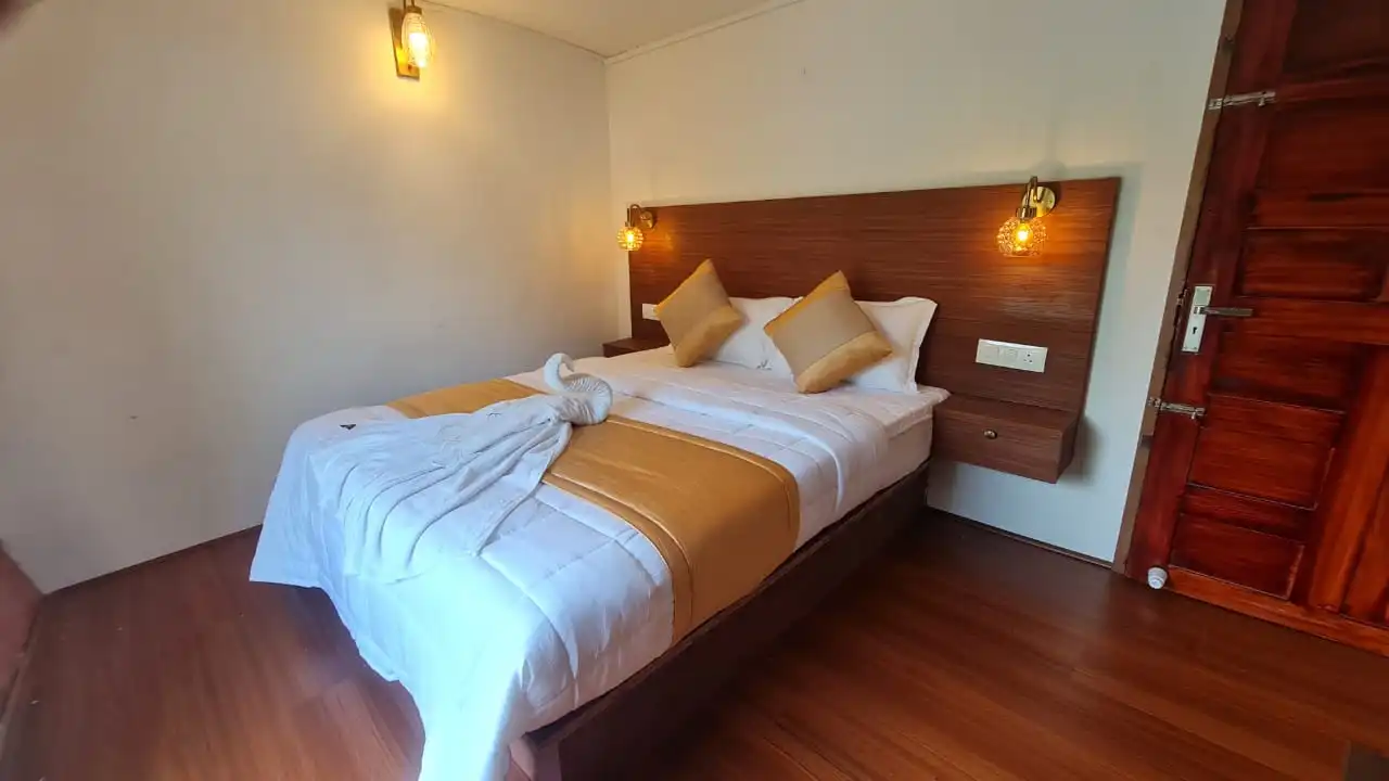 a bed with pillows and a wooden headboard